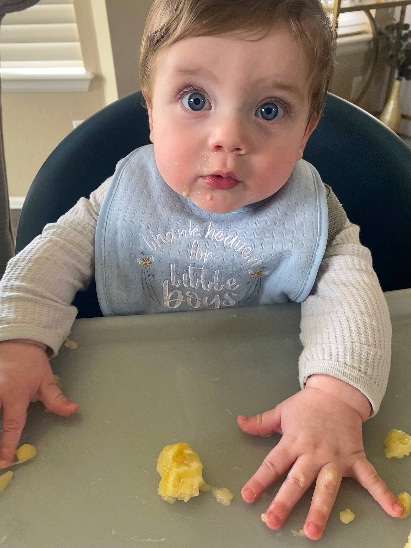 Ellis is registered to the contest to win money with this photo: baby, blade, cooking, eating, face, food, fruit, furniture, head, knife, mashingfood, meal, person, photography, plant, portrait, produce, sitting, snack, table