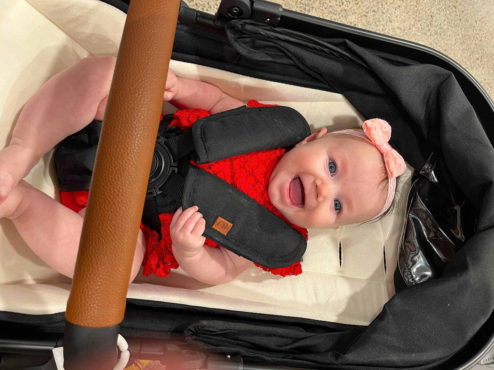 Bella is registered to the contest to win money with this photo: auto_part, baby, baby_carriage, baby_products, baby_safety, baby_toddler_clothing, bag, car_seat, carmine, child, comfort, infant_bed, people, person, sitting, toddler, wrist