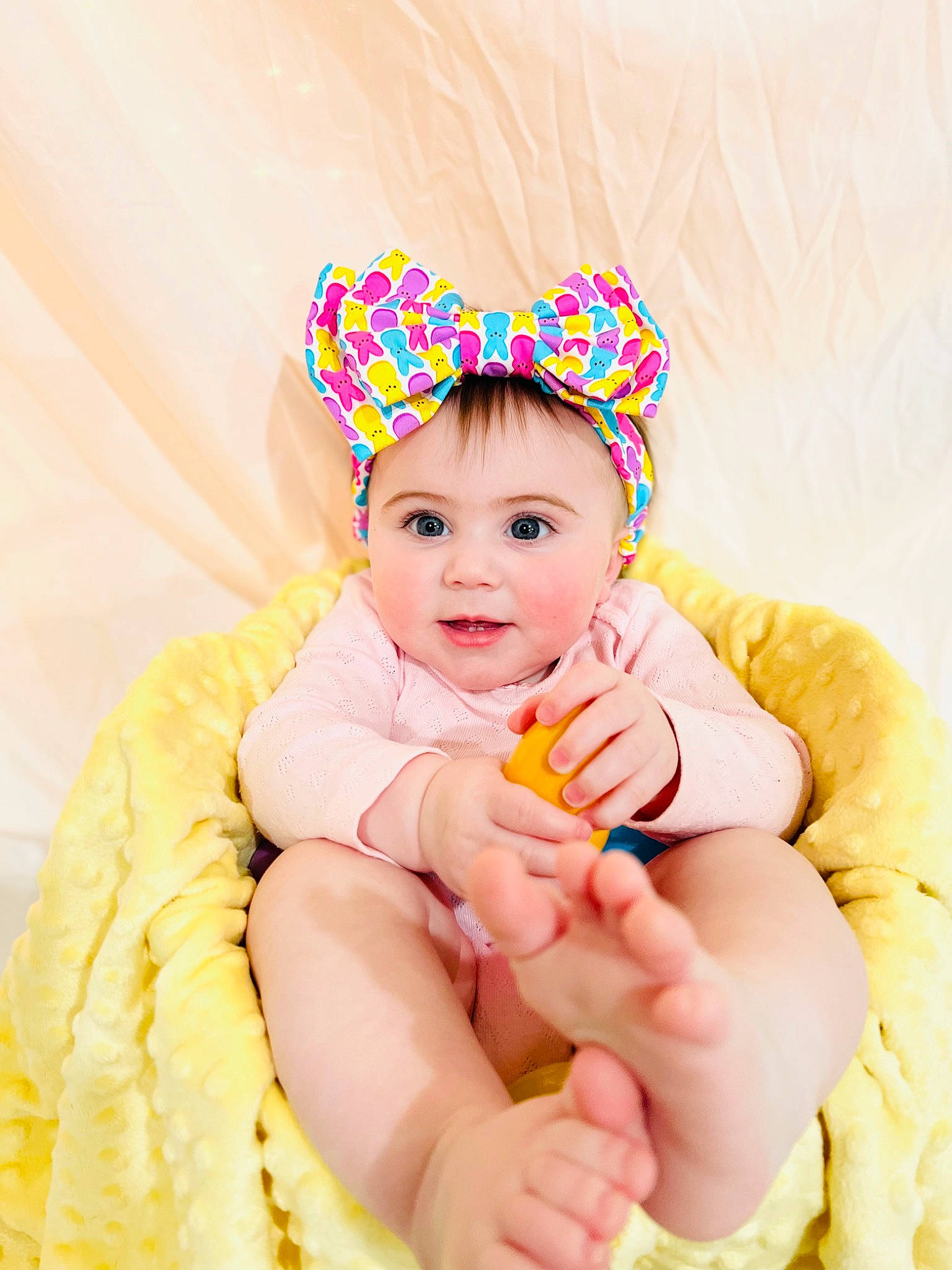 Madeline joined the competition — help win amazing prizes! baby, baby_playing_with_toys, baby_sleeping, baby_toddler_clothing, child, comfort, fun, gesture, hand, happy, head, headgear, headwear, human_body, orange, person, pink, sitting, skin, smile