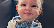 Juniper joined the competition — help win amazing prizes! baby, blue_eyes, child, clothing, couch, cute, denim_overalls, face, happy, heart_patch, indoor, infant, leather_couch, long_sleeve_shirt, natural_light, portrait, sitting, smiling, toddler, window