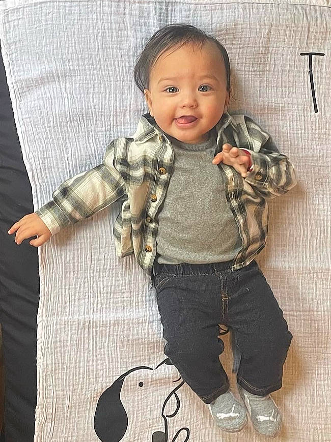 Kenyon is registered to the contest to win money with this photo: baby, baby_toddler_clothing, cheek, collar, cool, denim, dress_shirt, fashion_accessory, gesture, happy, outerwear, pattern, person, plaid, skin, sleeve, smile, t_shirt, thumb, toddler