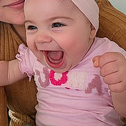 Jade participe au concours pour gagner de l'argent avec cette photo : baby, child, person, face, smiling, laughing, headband, pink_clothing, blue_pants, hand, adult, brown_sweater, closeup, indoor, happy, cute, joyful, expression, human, portrait