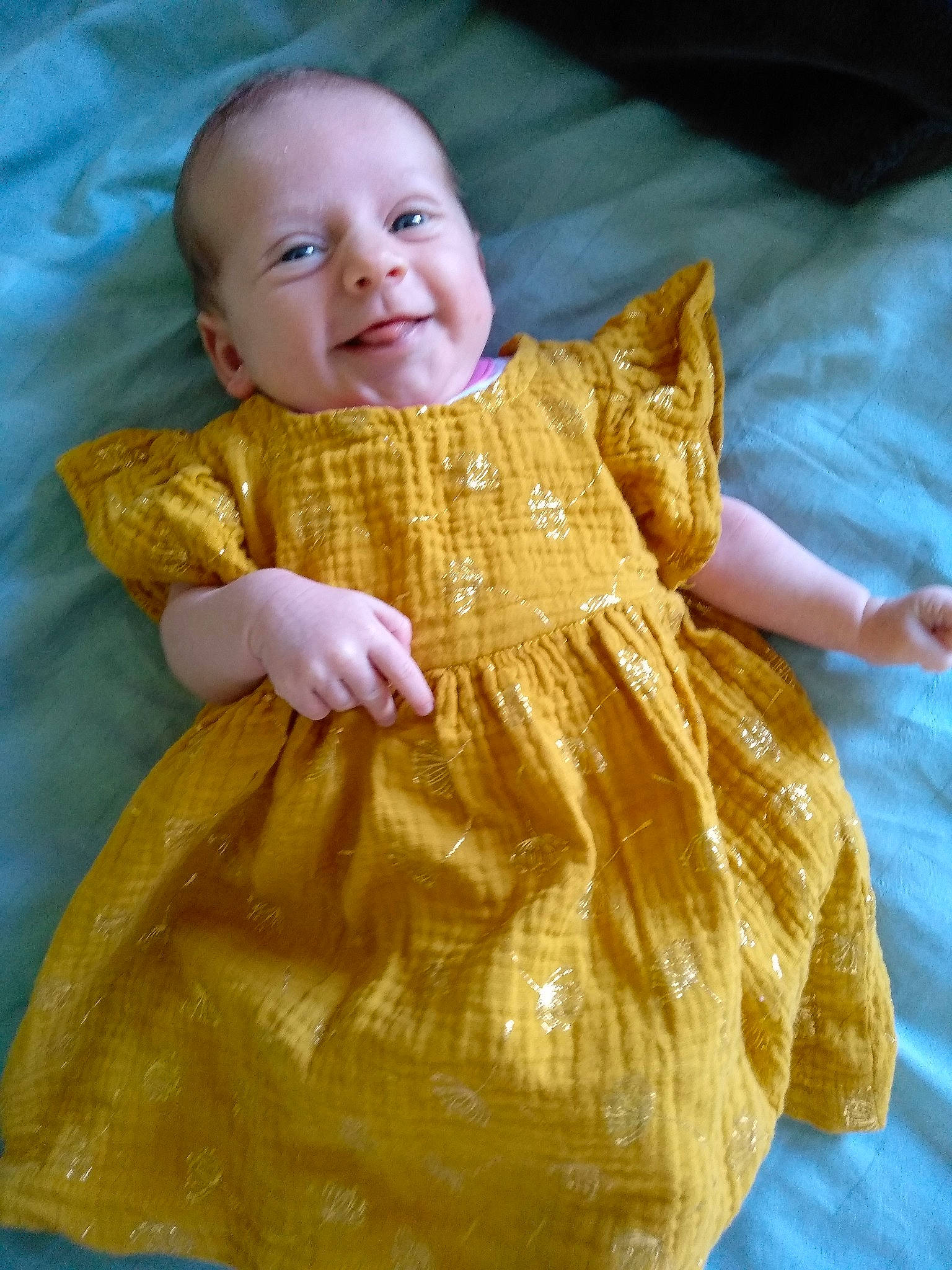 Faustine participe au concours pour gagner de l'argent avec cette photo : baby, baby_toddler_clothing, child, day_dress, dress, fashion_design, fawn, flooring, formal_wear, fun, happy, head, joy, one_piece_garment, orange, pattern, peach, person, sleeve, smile