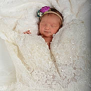 Maelyn joined the competition — help win amazing prizes! newborn, baby, sleeping, headband, flower, lace, blanket, white, soft, fabric, closeup, portrait, infant, peaceful, cute, wrapped, delicate, cozy, resting, tender