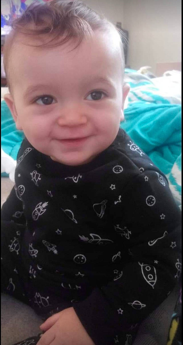 Legend is registered to the contest to win money with this photo: baby, baby_toddler_clothing, cheek, child, collar, comfort, eyelash, happy, iris, joy, lip, neck, nose, pattern, person, product, sitting, skin, sleeve, smile