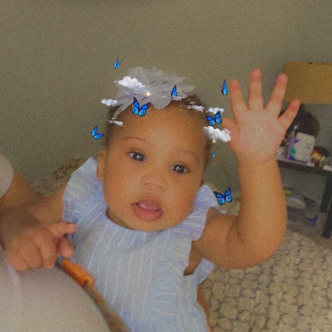 Neeah joined the competition — help win amazing prizes! baby, bed, blanket, blue_outfit, butterflies, child, clouds, cute, filter, furniture, hand, happy, headwear, indoor, infant, person, portrait, rainbow_flag, smiling, waving