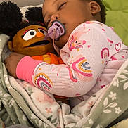 Neeah joined the competition — help win amazing prizes! bedtime, blanket, child, cozy, cuddling, cute, doll, earrings, face, indoor, pacifier, pajamas, pink, plush_toy, rainbow_pattern, resting, sleeping, soft_lighting, toddler, young_child