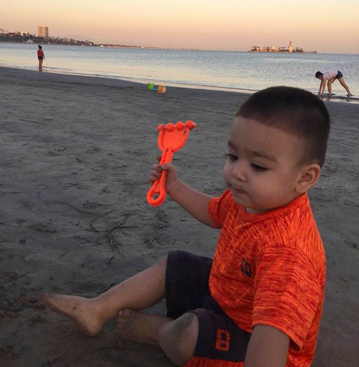 Adan is registered to the contest to win money with this photo: beach, child, fun, happy, ocean, person, play, sand, sea, sky, summer, toddler, vacation