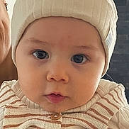 Mihran participe au concours pour gagner de l'argent avec cette photo : baby, child, hat, knit_hat, striped_clothing, indoor, portrait, face, eyes, cute, person, holding, hand, adult, warm_clothing, infant, expression, closeup, headwear, young