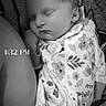 Violet joined the competition — help win amazing prizes! baby, newborn, sleeping, infant, portrait, black_and_white, floral_clothing, onesie, zipper, blanket, adult, snuggling, indoors, close_up, face, peaceful, resting, timestamp, grayscale, family