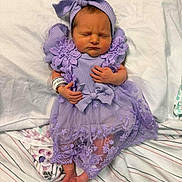 Violet joined the competition — help win amazing prizes! newborn, baby, sleeping, portrait, purple_outfit, dress, headband, bow, ruffles, flowers, hospital_bracelet, blanket, bedding, pillow, striped_fabric, lying_down, closed_eyes, hands, feet, indoor