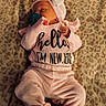 newborn, baby, sleeping, pink_outfit, headband, bow, pacifier, blanket, indoors, portrait, infant, lying_down, cozy, soft_lighting, textured_fabric, clothing, peaceful, baby_girl, closeup, photography