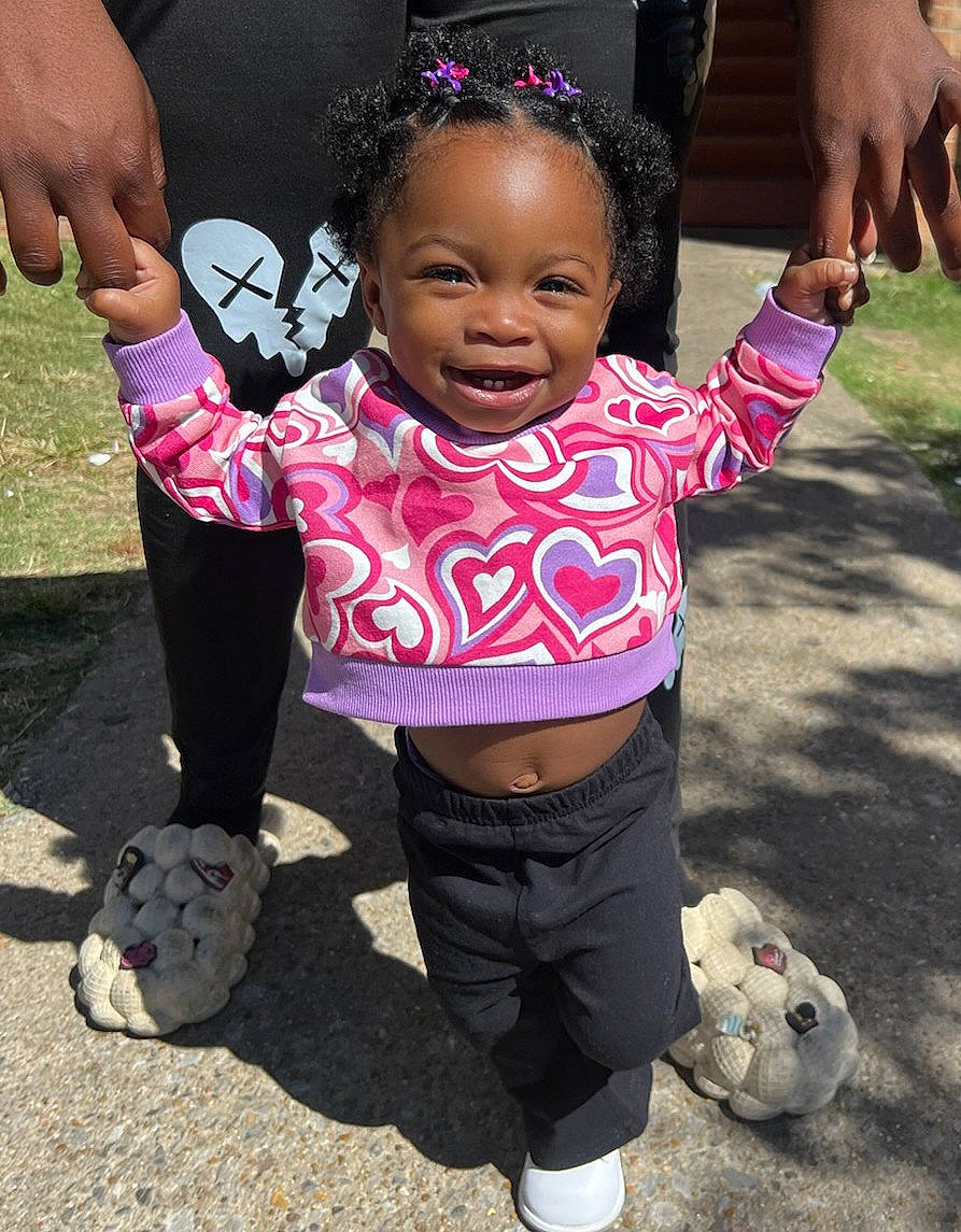 Ennsley Elise Barber is registered to the contest to win money with this photo: baby_toddler_clothing, child, cool, eye, face, finger, fun, gesture, hair, hand, happy, head, joy, leisure, people, person, pink, sleeve, smile, sneakers