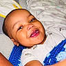 baby, smiling, blanket, blue, crochet, bed, bedding, infant, child, face, happy, person, portrait, sleepwear, lying_down, cuddly, cute, indoors, toddler, relaxed