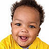 Imran is registered to the contest to win money with this photo: baby, child, smiling, happy, portrait, face, yellow_shirt, curly_hair, cute, innocent, closeup, expression, young, person, studio, bright, positive, joyful, eyelashes, skin