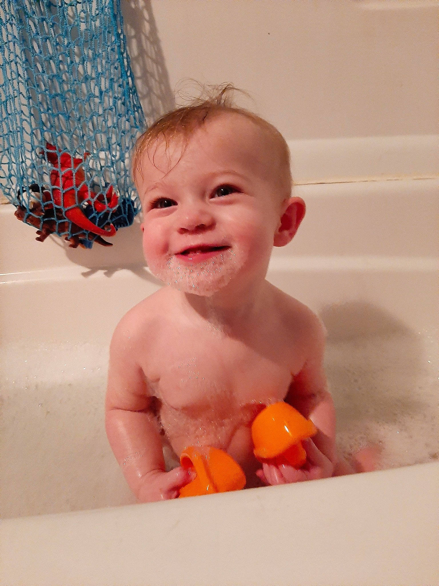 Mela joined the competition — help win amazing prizes! baby, baby_bathing, bath_toy, bathing, bathtub, child, face, facial_expression, fun, head, joy, orange, person, play, plumbing_fixture, room, skin, smile, toddler, washing