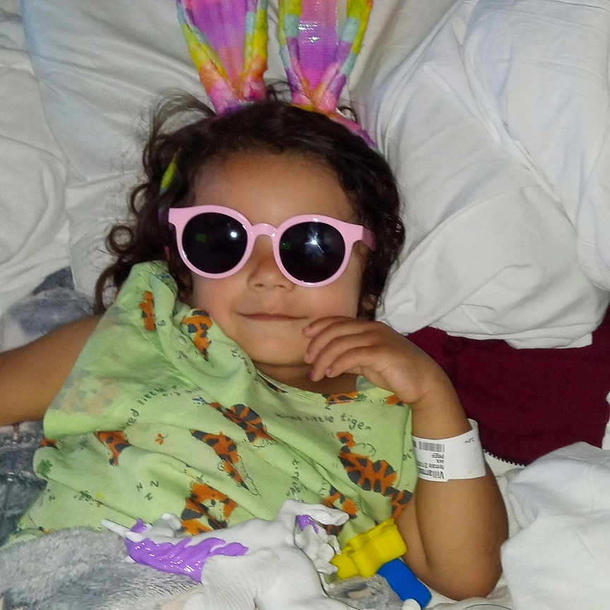 Chloe is registered to the contest to win money with this photo: accessories, architecture, baby, bed, bedroom, building, couch, cushion, face, furniture, glasses, head, homedecor, hospital, indoors, person, photography, portrait, room, sunglasses