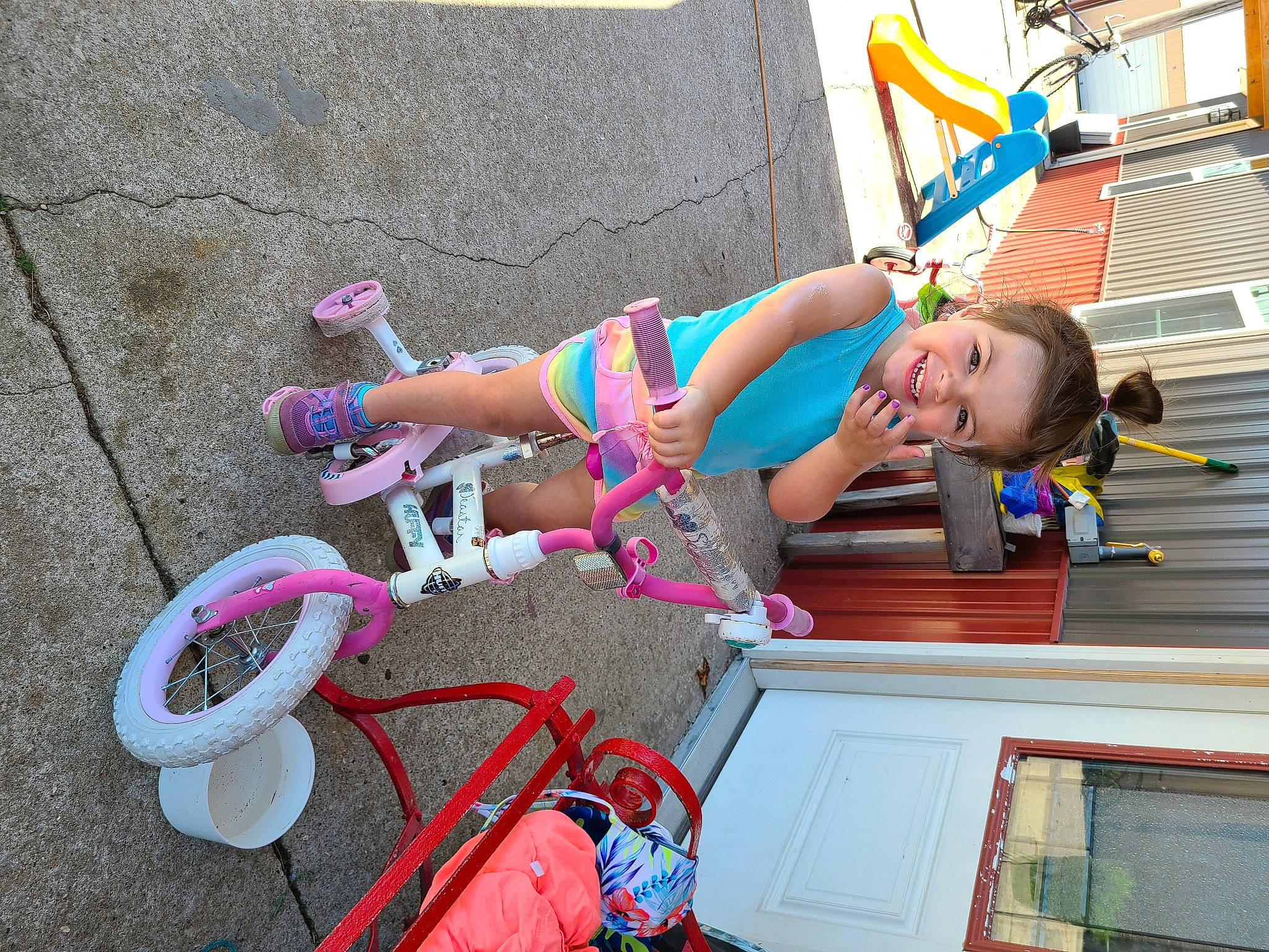 Houston is registered to the contest to win money with this photo: bicycle_accessory, child, electric_blue, fun, human_leg, joy, leg, leisure, magenta, person, pink, recreation, red, sandal, shorts, smile, sneakers, thigh, tire, toddler