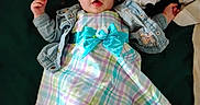 Olive is registered to the contest to win money with this photo: baby, baby_girl, bow, child, cute, denim_jacket, dress, flower, green_background, headband, indoor, infant, lying_down, pastel_colors, plush_toy, portrait, smiling, soft_toy, stuffed_animal, tights