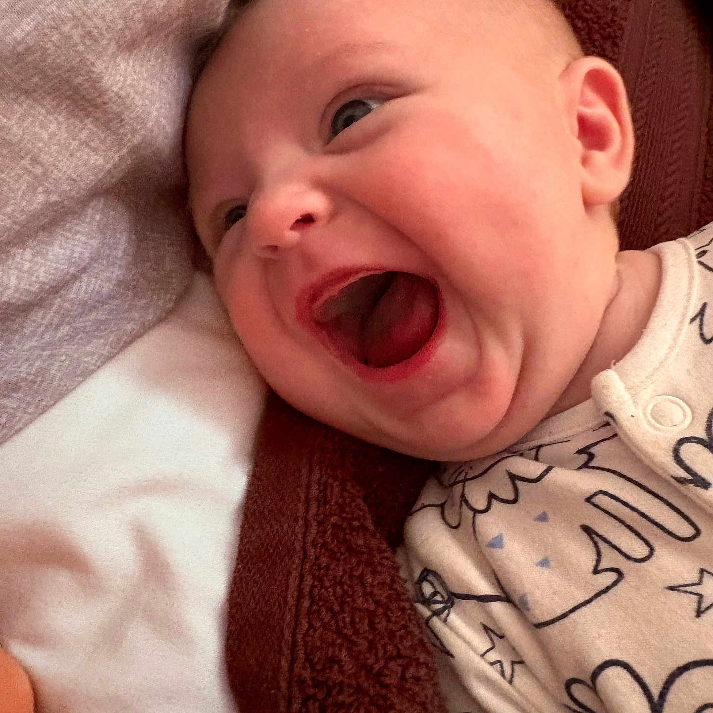 Iylee is registered to the contest to win money with this photo: baby, babylaughing, bed, blanket, bodypart, face, furniture, happy, head, laughing, mouth, newborn, person, photography, portrait, quilt, smile, teeth, tongue, towel
