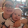 Oscar participe au concours pour gagner de l'argent avec cette photo : child, baby, indoor, glasses, smiling, hug, sibling, white_clothing, short_sleeves, person, face, happy, cute, home, furniture, table, chair, light, window, portrait
