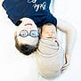 Arthur participe au concours pour gagner de l'argent avec cette photo : child, baby, glasses, sleeping, wrapped, blanket, soft, white_background, portrait, sibling, caring, infant, toddler, cute, happy, lying_down, closeup, family, love, rest