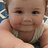 Eric joined the competition — help win amazing prizes! baby, child, smiling, closeup, indoor, curly_hair, face, arm, hand, carpet, blue_rug, pattern, crawling, cute, person, infant, skin, eyes, expression, white_tank_top
