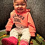 Isabelle joined the competition — help win amazing prizes! baby, child, girl, smiling, pink_hoodie, headband, sitting, blanket, animal_pattern, couch, cozy, happy, indoors, apparel, footwear, white_pants, pink_boots, face, person, portrait