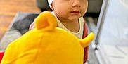 Isabelle joined the competition — help win amazing prizes! toddler, child, headband, plush_toy, winnie_the_pooh, indoor, living_room, carpet, couch, playpen, curly_hair, white_clothing, red_clothing, toy, baby, person, cute, soft_toy, expression, gaze