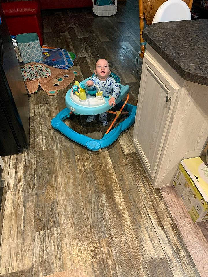 Jackie is registered to the contest to win money with this photo: chair, comfort, electric_blue, floor, flooring, fun, gas, hardwood, laminate_flooring, leisure, machine, person, plywood, room, sitting, table, toddler, varnish, wood, wood_flooring