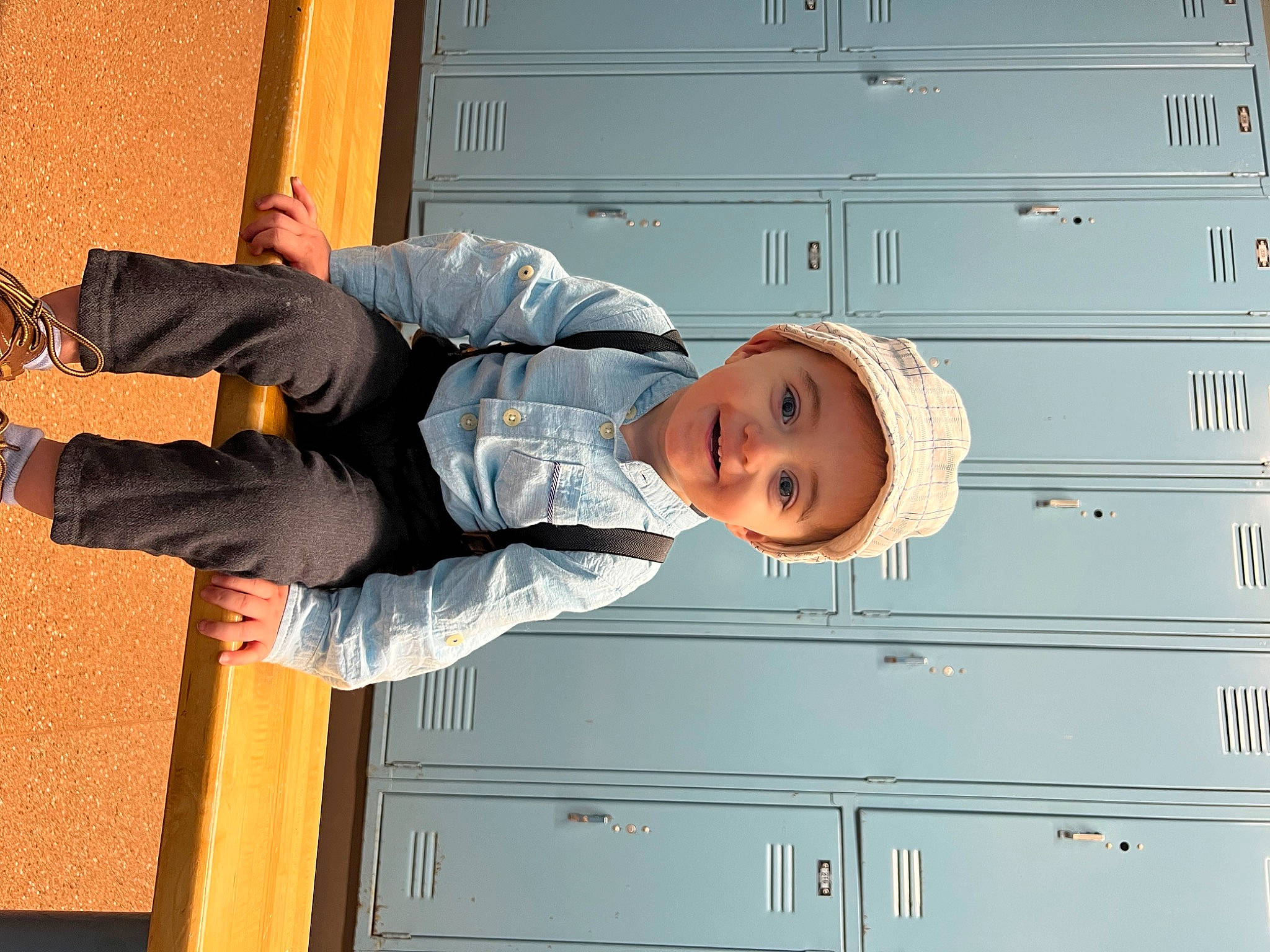 Bentley is registered to the contest to win money with this photo: cabinetry, denim, elbow, flash_photography, fun, happy, hat, headwear, human_leg, jeans, joy, knee, outdoor_shoe, person, sitting, space, standing, toddler, tree, walking_shoe