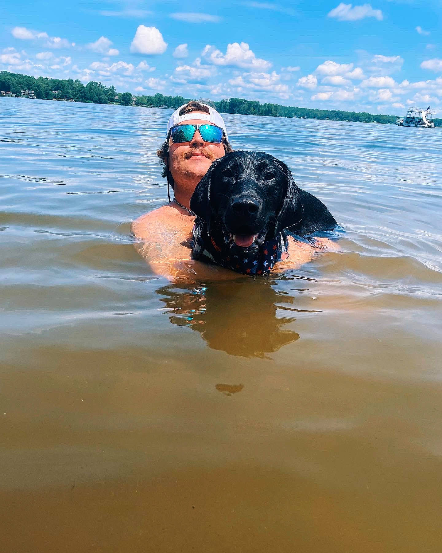 Gracie is registered to the contest to win money with this photo: beach, blue, carnivore, cloud, companion_dog, dog, dog_breed, fun, goggles, happy, hat, lake, leisure, ocean, personal_protective_equipment, recreation, sky, sporting_group, water, working_animal