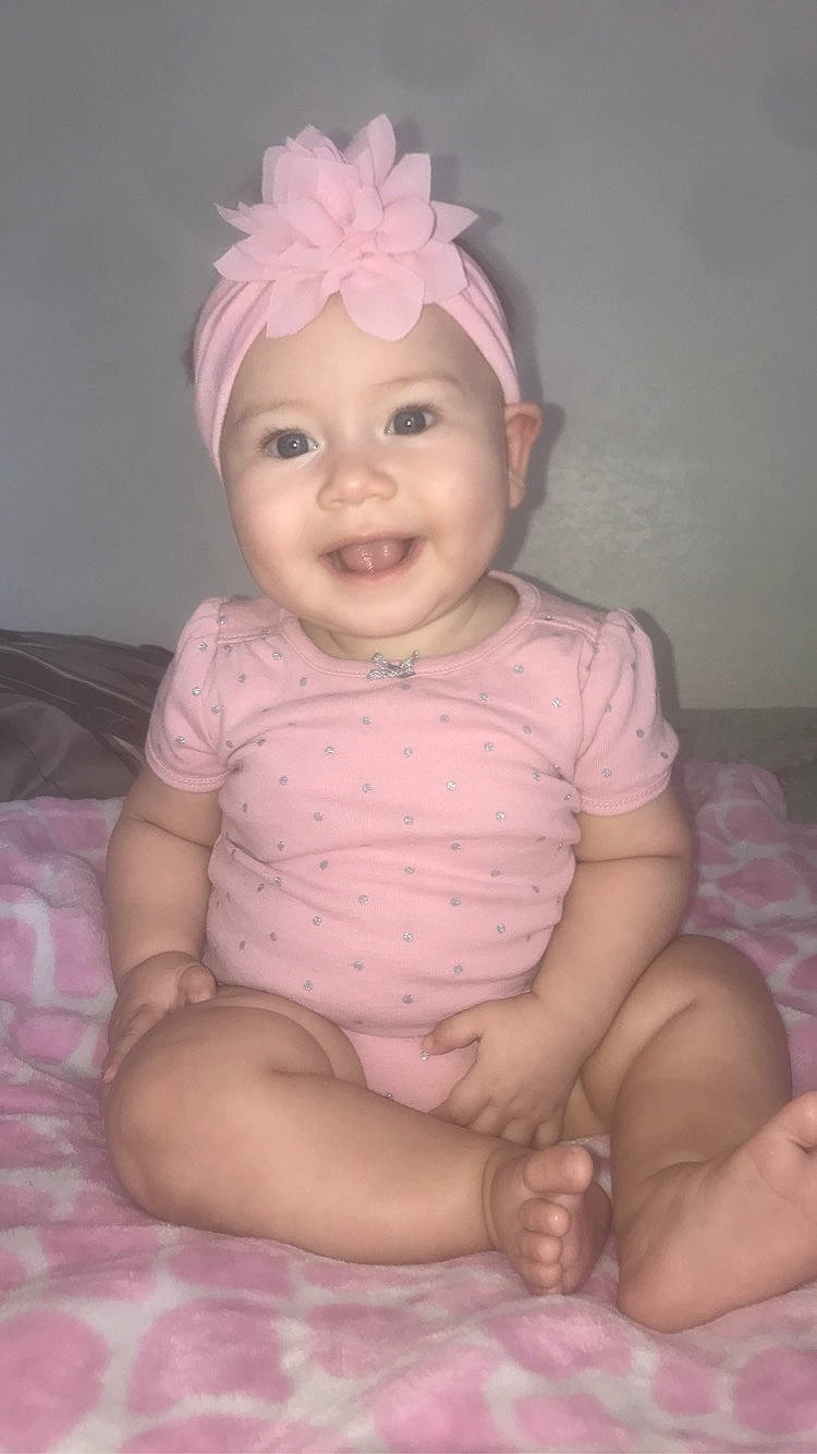 Starla joined the competition — help win amazing prizes! baby, baby_toddler_clothing, cheek, child, face, hair_accessory, head, headband, headgear, headpiece, headwear, iris, joy, lip, person, pink, sitting, skin, smile, toddler