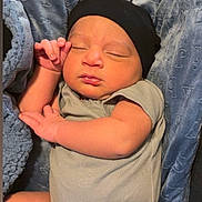 Dylan is registered to the contest to win money with this photo: baby, sleeping, infant, blanket, beanie, clothing, cute, peaceful, portrait, child, newborn, soft, resting, face, hand, cozy, indoor, toddler, warm, comfort