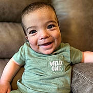 Cannon joined the competition — help win amazing prizes! baby, child, smiling, green_clothing, toddler, portrait, cute, happy, indoors, couch, furniture, face, young_child, casual_wear, pretty, sitting, human, infant, expression, relaxed
