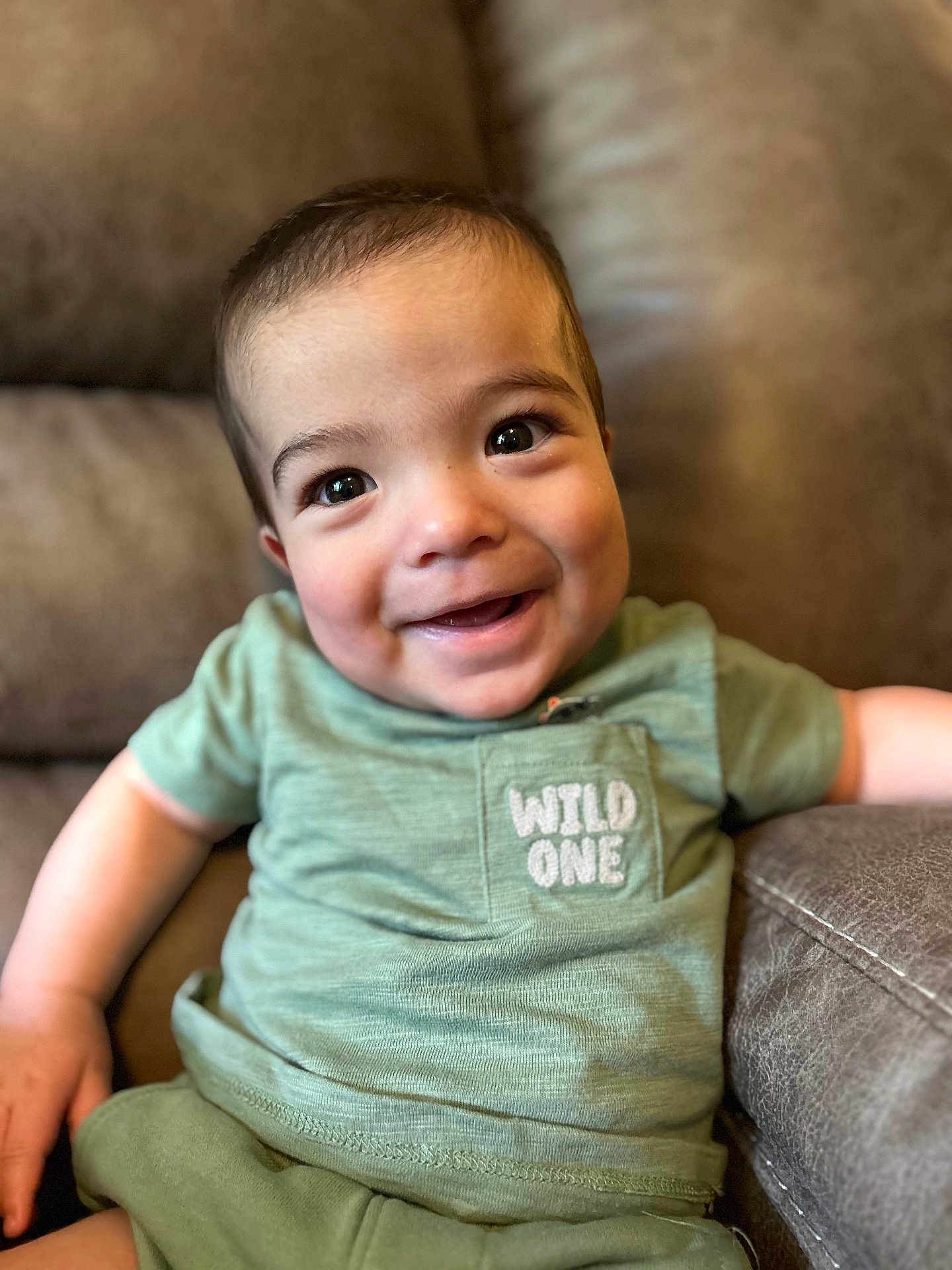 Cannon joined the competition — help win amazing prizes! baby, child, smiling, green_clothing, toddler, portrait, cute, happy, indoors, couch, furniture, face, young_child, casual_wear, pretty, sitting, human, infant, expression, relaxed