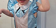 Willow joined the competition — help win amazing prizes! child, costume, alice_in_wonderland, blue_dress, headband, black_ears, smiling, portrait, indoor, door, playful, young_child, red_hair, curly_hair, white_collar, apron, floor, human, person, cute