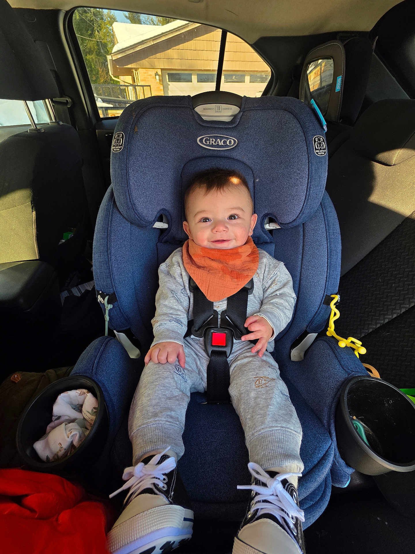 Dean joined the competition — help win amazing prizes! baby, child, car_seat, graco, smile, bib, sneakers, seatbelt, cupholder, vehicle_interior, window, sunlight, jumpsuit, hand, face, happy, backseat, fabric, toy, portrait