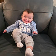 Dean is registered to the contest to win money with this photo: baby, infant, child, smile, tongue, armchair, leather_chair, clothing, onesie, socks, cheeks, happy, portrait, sitting, indoors, cute, tiny_hands, short_hair, photography, mamas_little_man