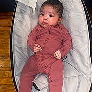Zoey joined the competition — help win amazing prizes! baby, infant, onesie, baby_seat, cushion, wooden_floor, indoor, child, portrait, comfortable, clothing, cute, face, looking, resting, soft_texture, young_child, hands, feet, relaxed