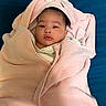 Zoey joined the competition — help win amazing prizes! baby, child, towel, pink_towel, hooded_towel, face, portrait, blanket, soft, cute, infant, lying_down, blue_background, wrapped, clothing, expression, indoors, resting, young_child, warm