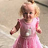 Athena is registered to the contest to win money with this photo: toddler, child, girl, curly_hair, pink_dress, bunny_applique, top_knot, standing, outdoor, portrait, cute, innocent, curious, fashion, young_child, person, smiling, baby, soft_lighting, closeup