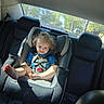 Athena joined the competition — help win amazing prizes! automobile, baby, car, car_seat, child, child_safety, curly_hair, cute, happy, infant, portrait, rear_window, safety, seat, seatbelt, smile, sunlight, toddler, vehicle_interior, young_child