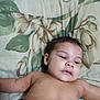 Jakai is registered to the contest to win money with this photo: baby, child, infant, face, skin, lying_down, pillow, floral_pattern, expression, resting, indoors, young, cute, portrait, head, arm, bare_chest, sleepy, calm, soft_light