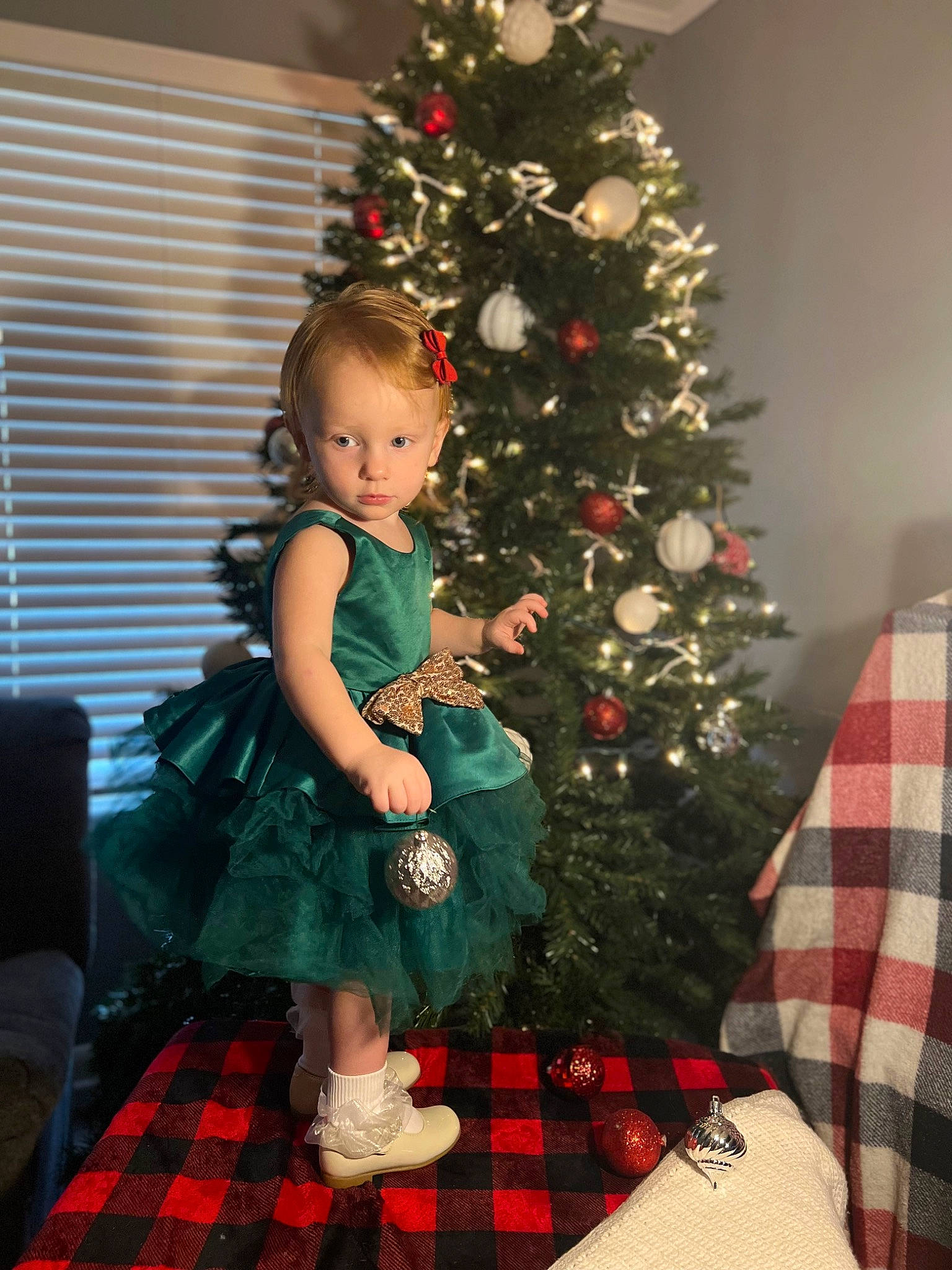 Aliyah Weaver joined the competition — help win amazing prizes! christmas, christmas_decoration, christmas_eve, christmas_ornament, christmas_tree, dress, event, evergreen, hair, holiday, holiday_ornament, lap, pattern, person, plaid, plant, red, tartan, toddler, tree