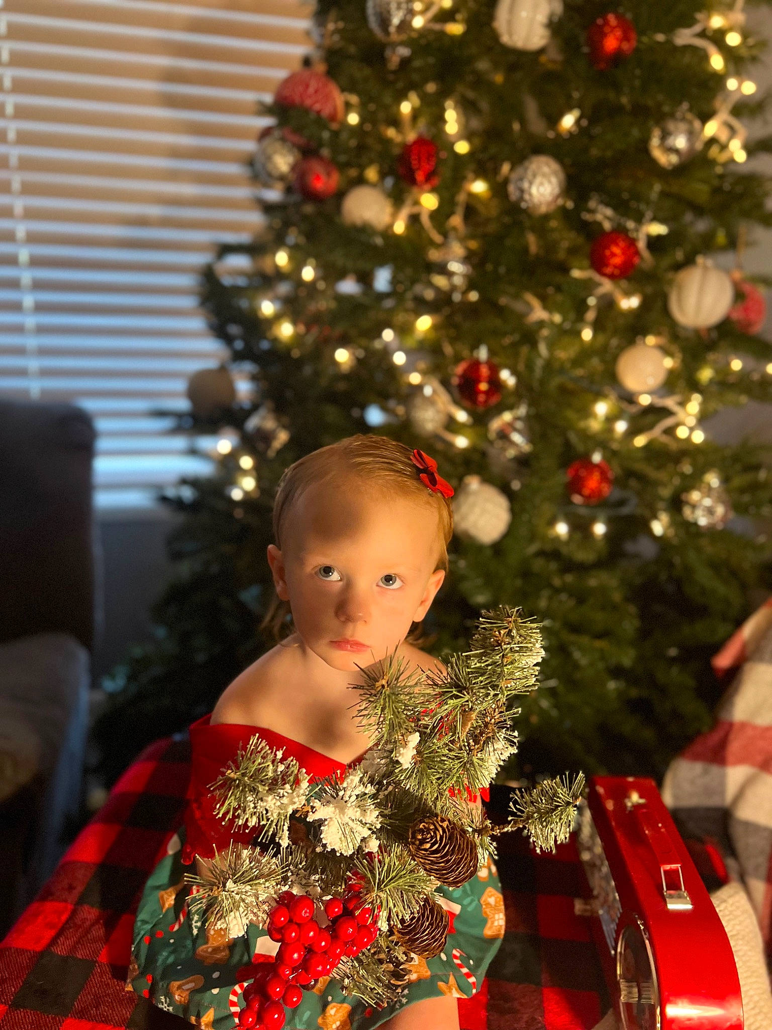 Aliyah Weaver joined the competition — help win amazing prizes! christmas, christmas_decoration, christmas_eve, christmas_ornament, christmas_tree, conifer, dress, event, evergreen, fashion_design, holiday, holiday_ornament, light, ornament, person, plant, red, toddler, tradition, tree