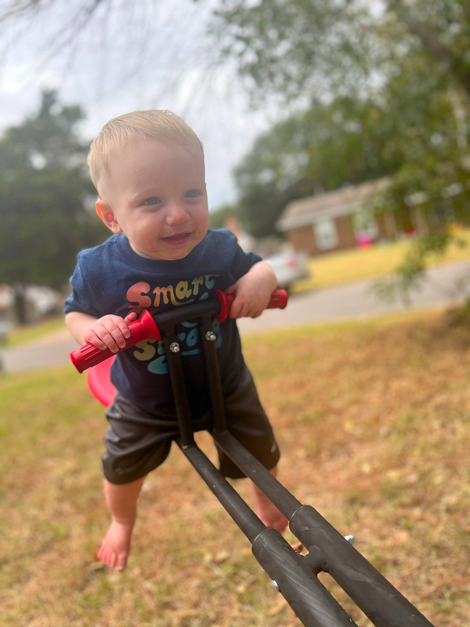 Ellis is registered to the contest to win money with this photo: baby, baby_toddler_clothing, dress, fun, grass, happy, leaf, leisure, people_in_nature, person, plant, recreation, shorts, sitting, sky, smile, sunlight, swing, t_shirt, toddler