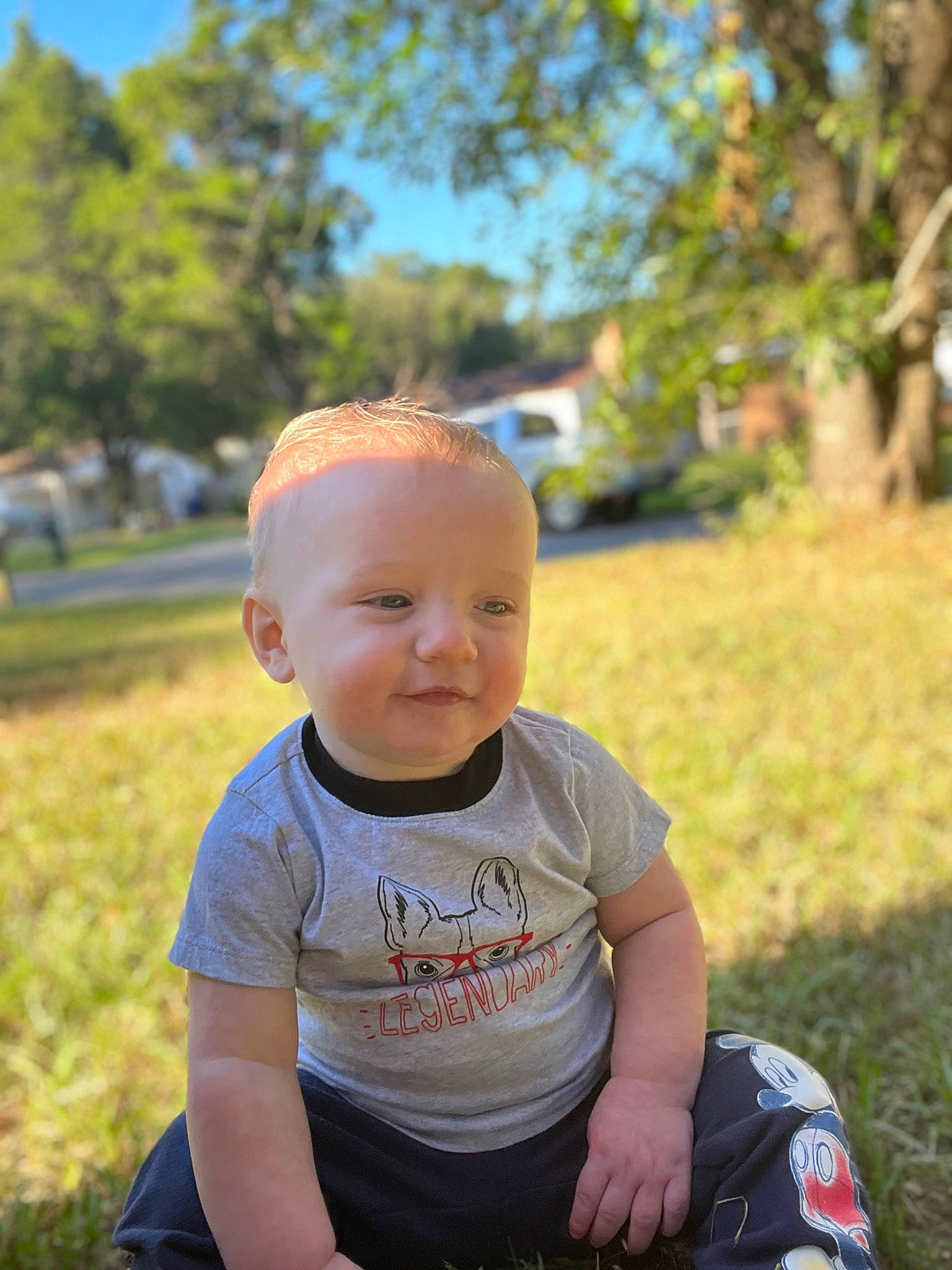 Ellis is registered to the contest to win money with this photo: baby, baby_toddler_clothing, chin, electric_blue, facial_expression, fun, grass, happy, leisure, mammal, people_in_nature, person, plant, recreation, sitting, skin, smile, summer, toddler, tree