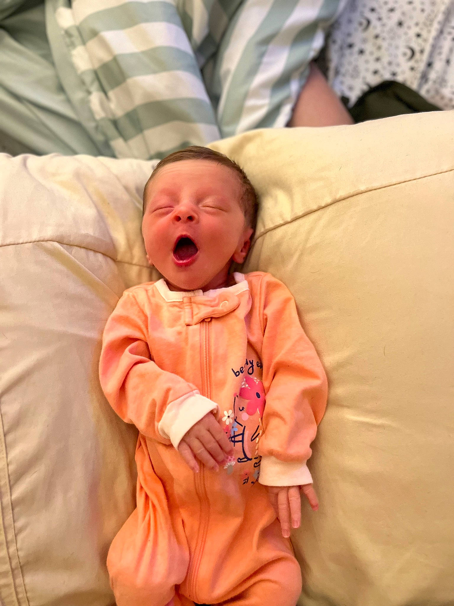 Elizabeth is registered to the contest to win money with this photo: baby, baby_toddler_clothing, bed, bedding, cheek, child, comfort, couch, facial_expression, fun, happy, linens, mouth, nose, orange, person, sitting, skin, sleeve, toddler