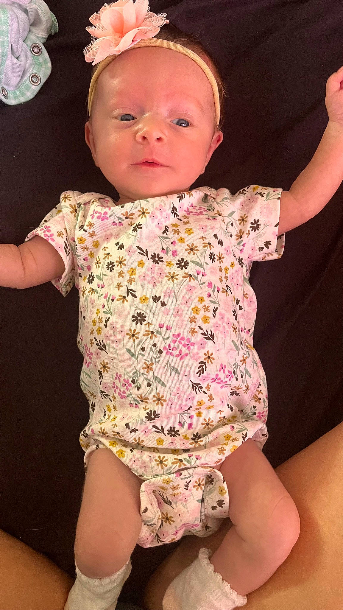 Elizabeth is registered to the contest to win money with this photo: arm, baby, baby_toddler_clothing, cheek, child, eye, face, finger, gesture, head, human_body, joint, neck, person, pink, skin, sleeve, thigh, thumb, toddler